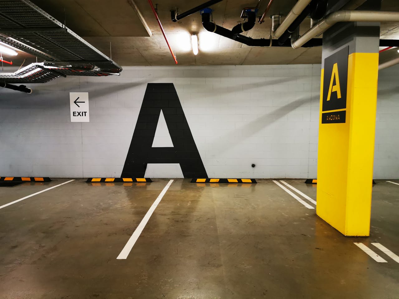 about-04 Underground parking space with large letter 'A' and exit sign in Surfers Paradise.