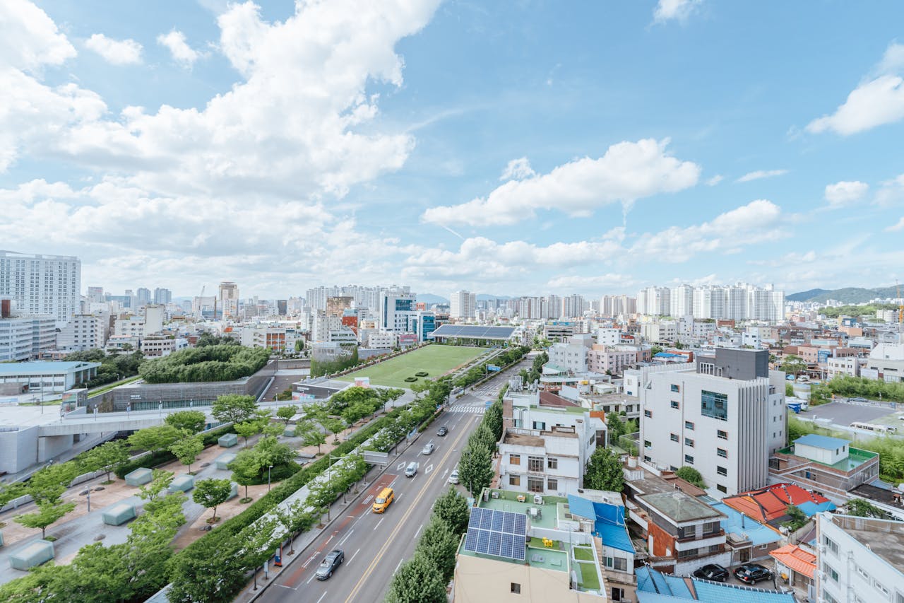 Aerial view of a bustling cityscape with modern architecture and blue sky.