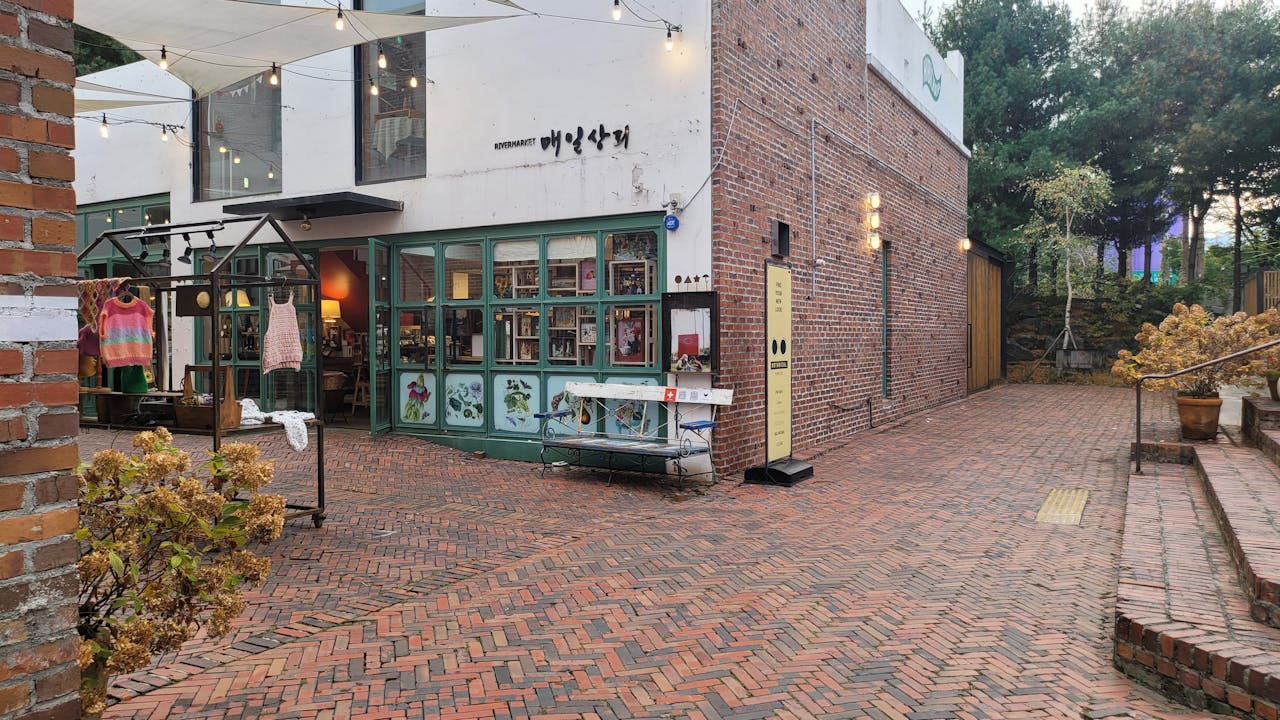 Rustic brick alley with a quaint storefront displaying handmade crafts.